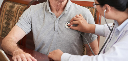 Doctor measuring a patient’s heart and lungs during an acute and chronic condition consultation at Silverdale Doctors