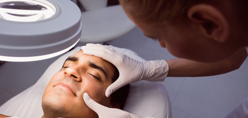 Clinician performing a minor skin procedure on a patient’s face for skin checks at Silverdale Doctors