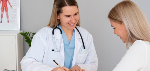 Female GP speaking with a patient during a women's health consultation